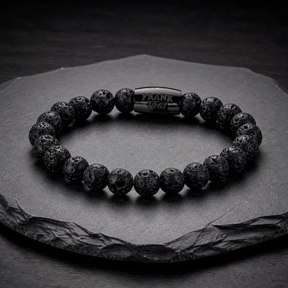 Frank 1976 Armband aus Lavastein auf Schieferplatte